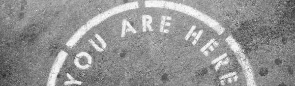 A white semi circle on a ground background with the wording 'YOU ARE HERE'