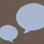 Two white speech bubbles against a sandy brown background