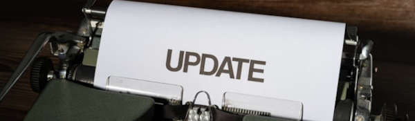 Paper with typed 'UPDATE' in the roller of a typewriter